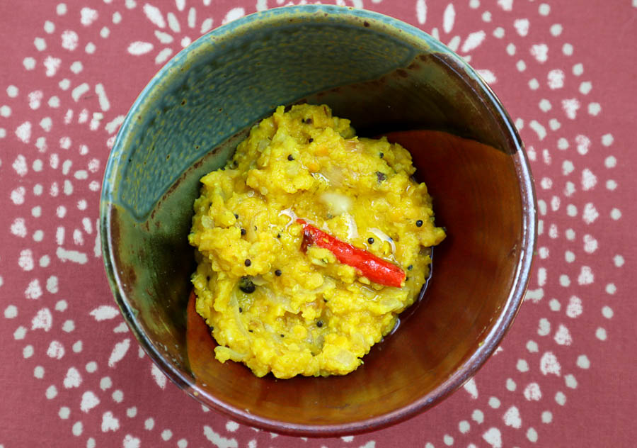 Spicebush berry dal with chile pepper in ceramic bowl